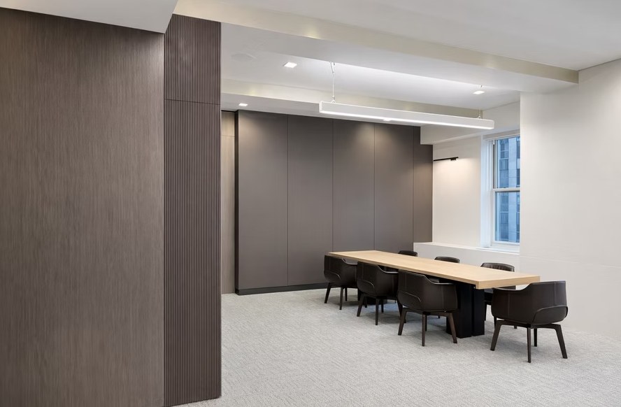 Conference room with custom wood wall paneling and fluted millwork by DKT